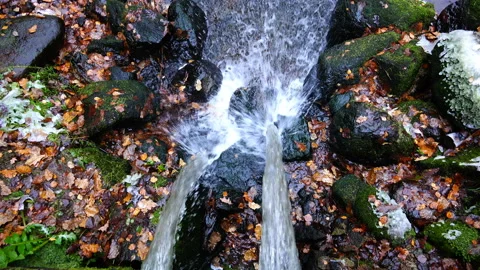 A jet of water falls down, blurring the water mirror Stock Footage 90073627