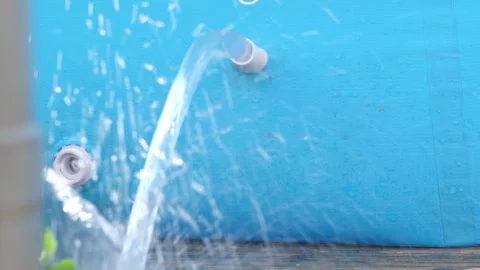 Jet of water flows out of a blue swimming pool Stock Footage 250006549