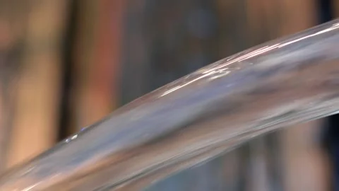 Jet of water flows out of a blue swimming pool onto wooden decking Stock Footage 250006605