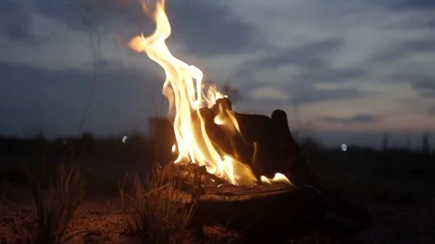 Jet of water pours on burning boot Strong bright flame summer dark night Slow mo Video stock 95910864