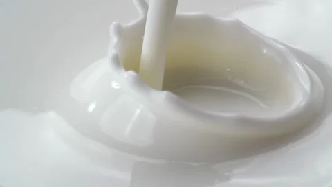 Jet of white milk powerfully beats into container. Stock Footage 175151664
