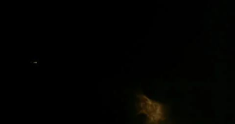 Jetliner with intense sheet-lightning that illuminates late-night storm clouds. Stock Footage 320374655
