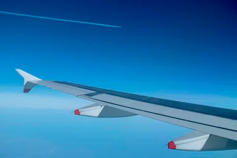 Jetliners speeding across the blue sky Stock Photos