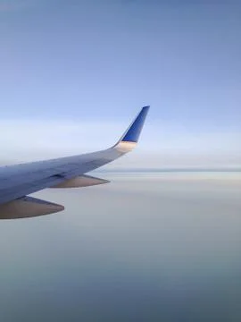 Jetplane Wing over Smooth Clouds Stock Photos