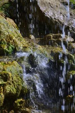 Jets of clean and cold spring water of the Plakun waterfall on the right bank Stock Photos