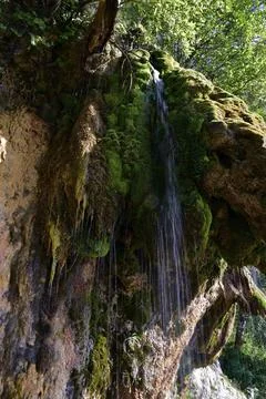 Jets of clean and cold spring water of the Plakun waterfall on the right bank Stock Photos