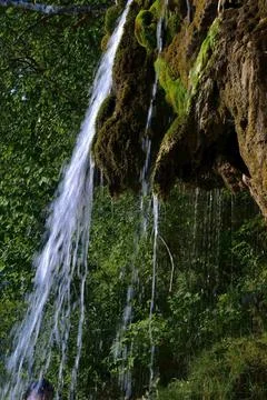Jets of clean and cold spring water of the Plakun waterfall on the right bank Stock Photos