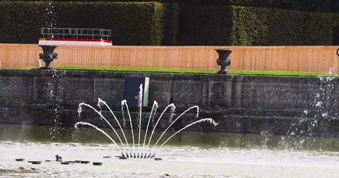 The jets of the Poseidon Fountain in Versailles form the silhouette of a fle Stock Footage 344936294