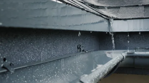 Jets of rain drain into the drainage system on the roof of the house Stock Footage 144668767
