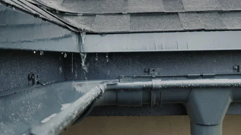Jets of rain drain into the drainage system on the roof of the house Stock Footage 146012767