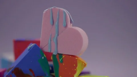 Jets of thick nail polish flow down the surface of the make-up sponge. Stock Footage 77512161