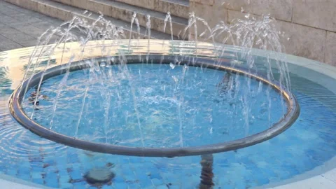 Jets of water fall into a blue pool Stock Footage 169370820