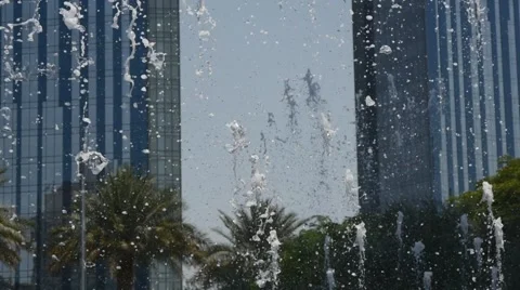 Jets of water fly up between two skyscrapers Stock Footage 62810106
