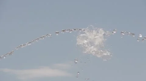 Jets of water occurring against the backdrop of a cloudless sky. Slow motion. Stock Footage 54096212