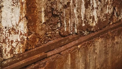 Jets of water run down a rusty muddy wall when it rains. Stock Footage 308015117