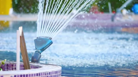 Jets of water spraying into a pool, creating lively splashes and a refreshi.. 스톡 동영상 293121821