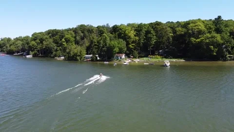 A JETSKI RIDING INTO THE DOCK Stock Footage 158392141