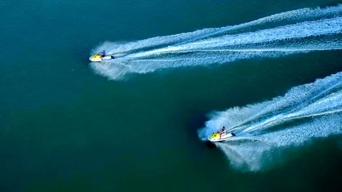 Jetskis Pass by Caribbean Resort by Aerial Drone Stock Footage