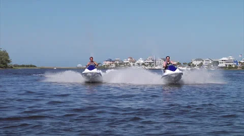 Jetskis split on waterway, 60fps Stock Footage 24636876