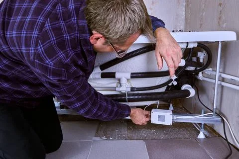 Jetted bathtub installing, mount electrical box for whirlpool tub. Stock Photos