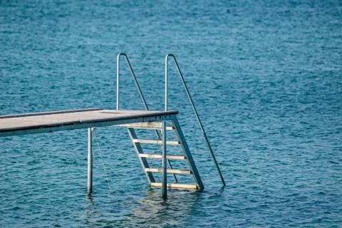 Jetty at a blue ocean Stock Photos