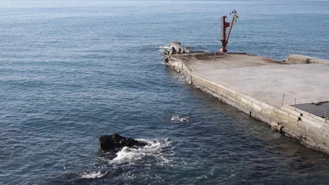 Jetty with crane at Genoa with rocks Stock Footage 101928078