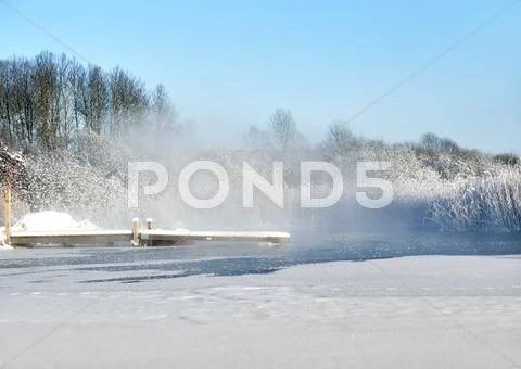 Jetty in lake in winter Stock Photos