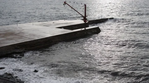Jetty with red crane in the rough sea Stock Footage 101195507