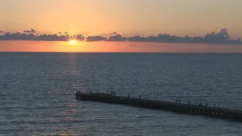 Jetty at sunset with people walking Stock Footage 105055940
