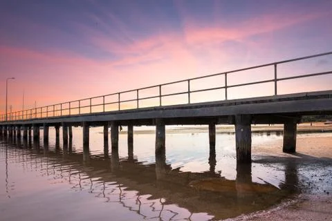 Jetty with Tide Out at Sunset. Stock Photos