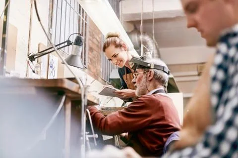 Jeweler and apprentice working in workshop Stock Photos