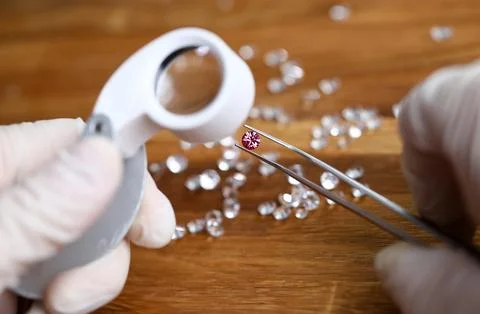 Jeweler checking gem for identity Stock Photos