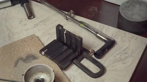 The jeweler disassembles the mold and takes out a silver casting. Video stock 147415043