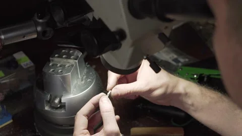 Jeweler examines the ring under a microscope. Stock Footage 153549437