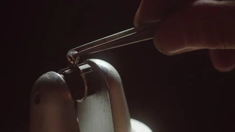Jeweler fitting gem on ring in dark workshop Video stock 253433296