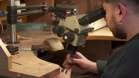 Jeweler looks through the microscope Stock Footage 73597287