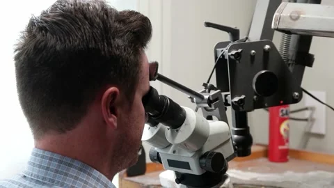 Jeweler Looks Through The Microscope in the workshop Stock Footage 131549807