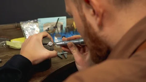 Jeweler manually prepares a silver ring for inlaid gems Stock Footage 73527358