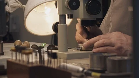A jeweler by the microscope Stock Footage 74913218