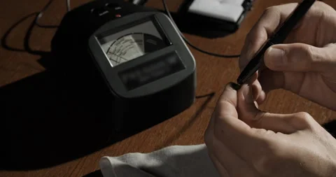 Jeweler or gemologist checking quality of gemstone with gem tester. Close-up Stock Footage 247895507