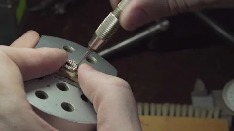 Jeweler prepares a silver ring to insert precious stones. Stock Footage 147416111