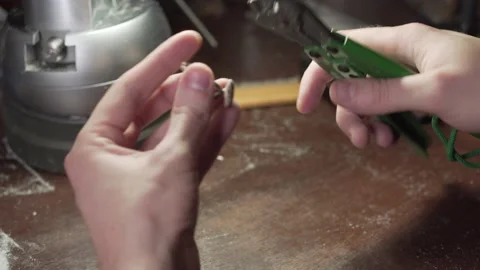 Jeweler separates the silver billets with wire cutters. Goldsmith at work. Stock Footage 153549095