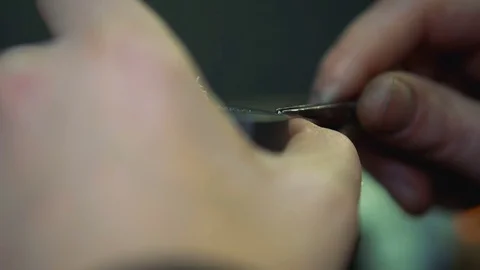 Jeweler takes gem using forceps and insert it into the silver ring close-up Stock Footage 73553220