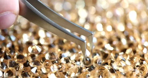 Jeweler taking diamond from pile with tweezers closeup 4k movie slow motion Vídeos de archivo 220031291