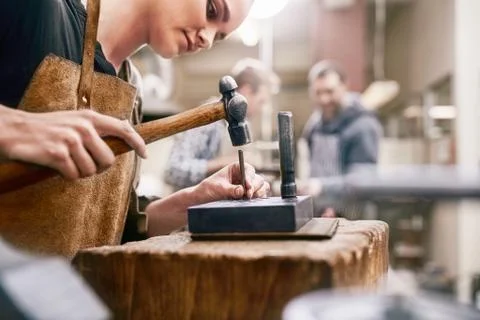 Jeweler using hammer in workshop Stock Photos