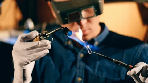 Jeweler welds a ring, using a burner. Stock Footage 124432758