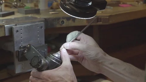 Jeweler working on wedding ring in workshop under light Stock Footage 82396957