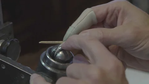 Jeweler working on wedding ring in workshop finishing touches Stock Footage 82399915