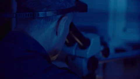 The jeweler works with a microscope Stock Footage 84692316