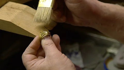 Jeweler in the workshop cleans the ring Stock Footage 108342882